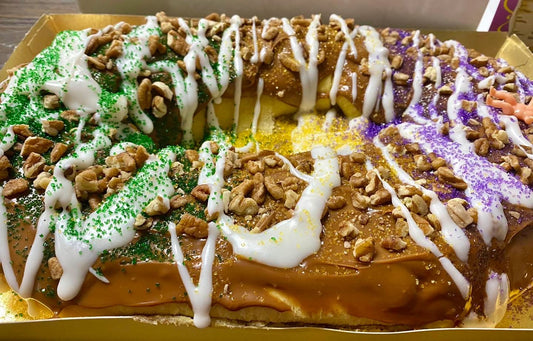 Pecan Praline King Cake topped with caramel and toasted pecans