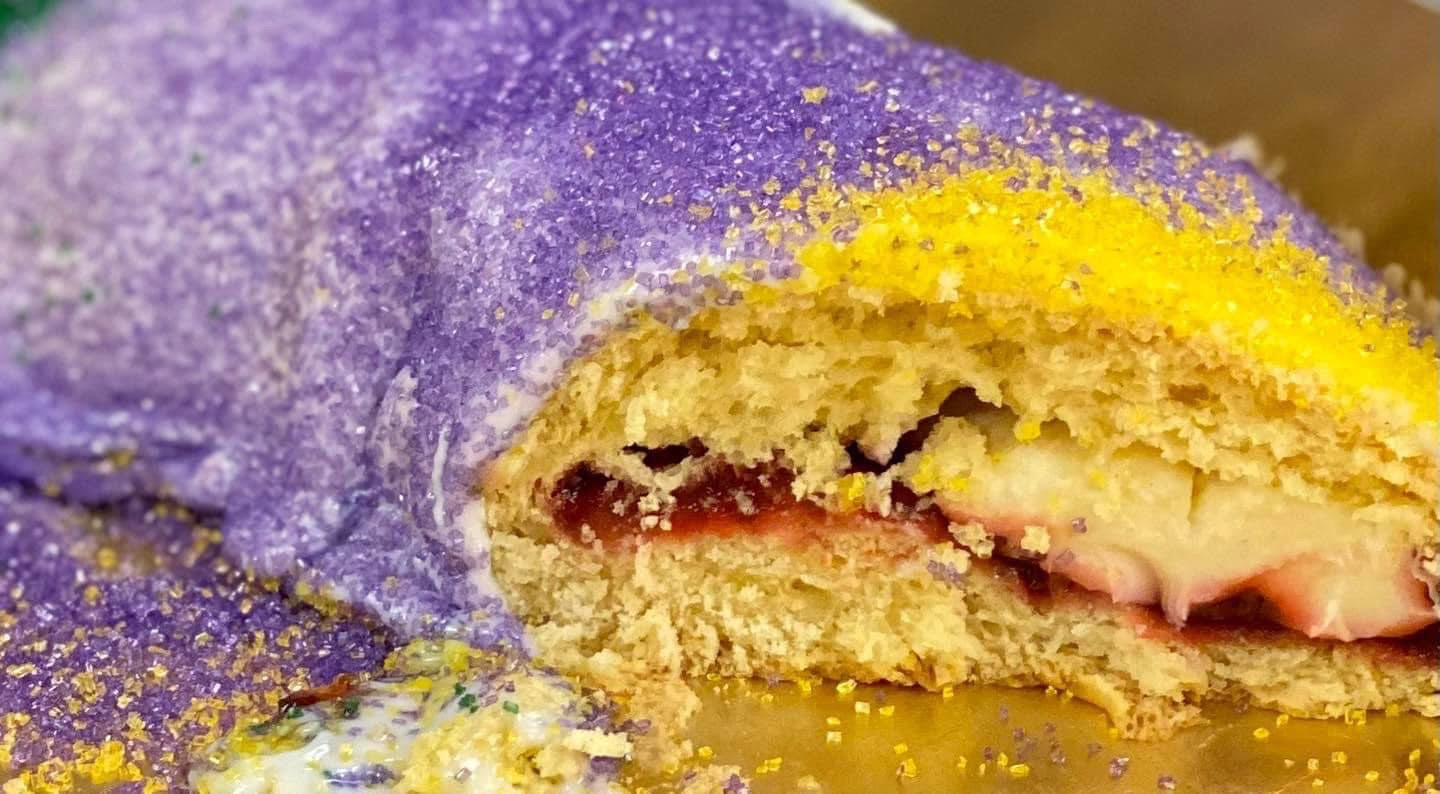 Strawberry and cream cheese king cake with classic icing and festive sugar on soft dough